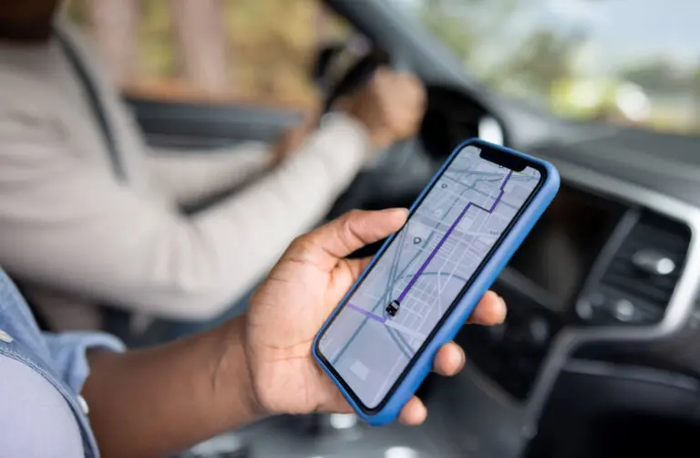 Close-up on an African American couple using the GPS in a rideshare on a cell phone while driving a car in middletown ,ct