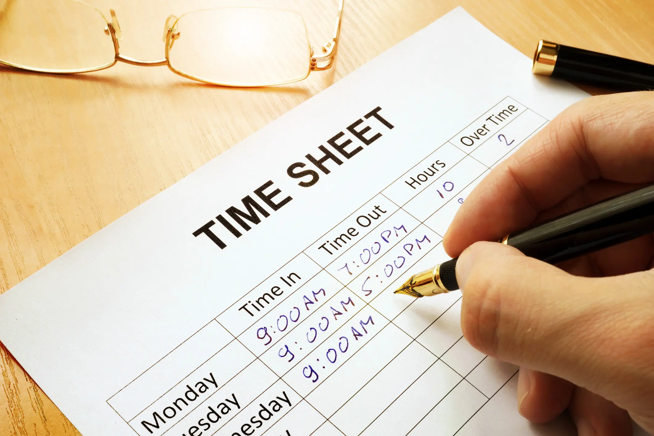 Records work hours in a time sheet.