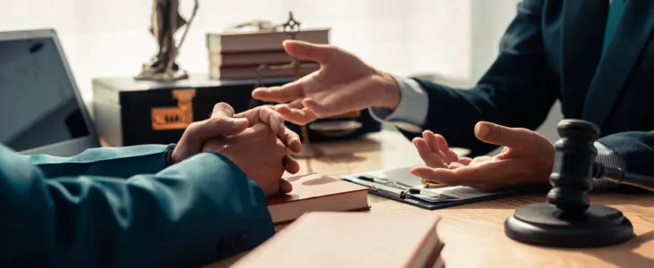 Legal malpractice attorney talking with client.